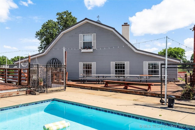 168 Murray Ln, Strang, OK 74367 - rear view of house with a gambrel roof, a patio area, and a chimney