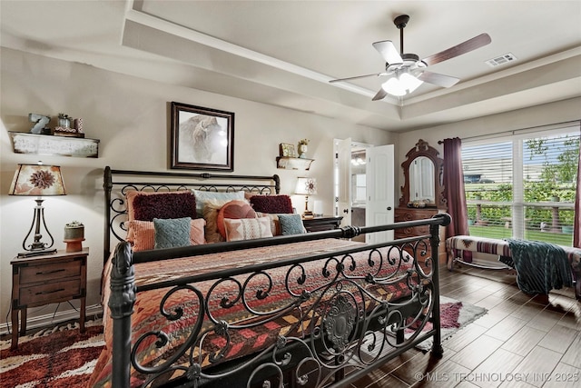 3501 W Gary St S, Broken Arrow, OK 74012 - bedroom with a raised ceiling, wood finished floors, and a ceiling fan