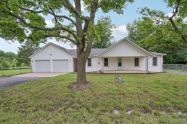 915 N Boudinot Ave, Dewey, OK 74029 - ranch-style house with asphalt driveway, an attached garage, and a porch