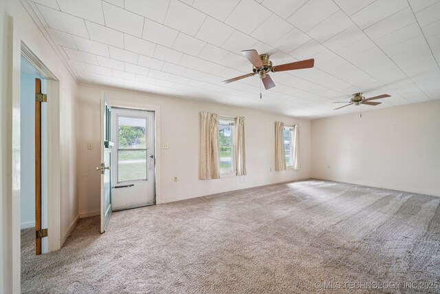 915 N Boudinot Ave, Dewey, OK 74029 - unfurnished room with carpet floors, ceiling fan, and baseboards