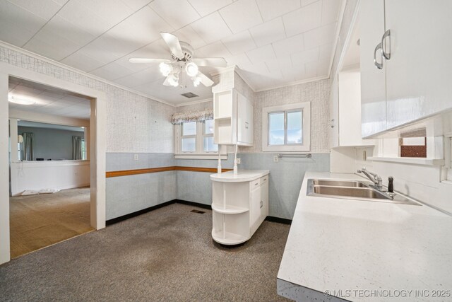 915 N Boudinot Ave, Dewey, OK 74029 - kitchen featuring a sink, crown molding, a ceiling fan, white cabinets, and open shelves
