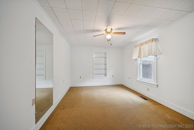 915 N Boudinot Ave, Dewey, OK 74029 - carpeted spare room with ceiling fan, built in features, baseboards, and crown molding