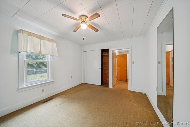 915 N Boudinot Ave, Dewey, OK 74029 - unfurnished bedroom featuring carpet, baseboards, a closet, and crown molding