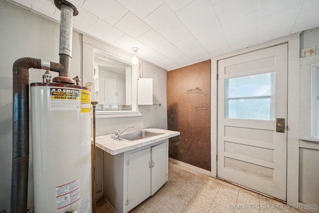 915 N Boudinot Ave, Dewey, OK 74029 - washroom featuring gas water heater, a sink, and light flooring