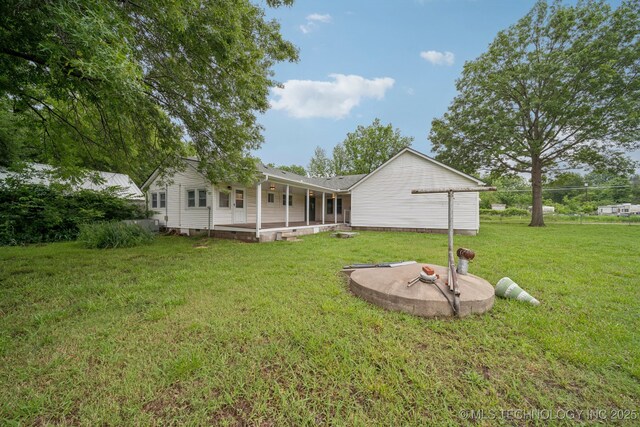 915 N Boudinot Ave, Dewey, OK 74029 - back of property with a lawn and a patio area