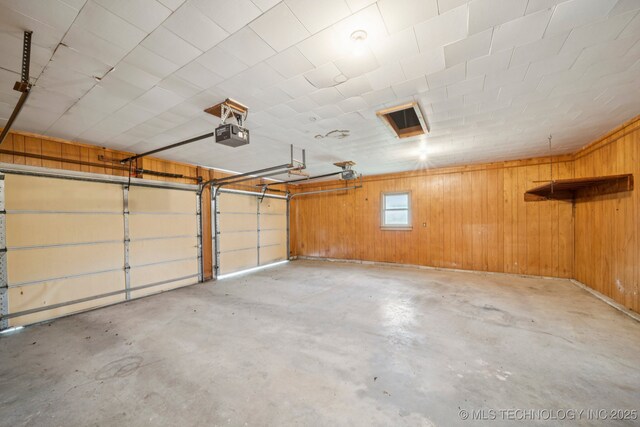 915 N Boudinot Ave, Dewey, OK 74029 - garage with wooden walls and a garage door opener