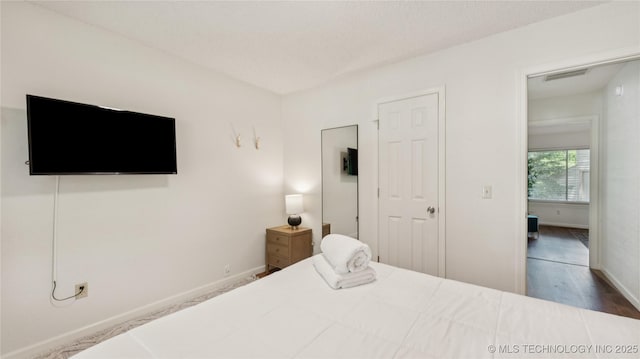 3021 S Ash Ave, Broken Arrow, OK 74012 - bedroom featuring baseboards and wood finished floors