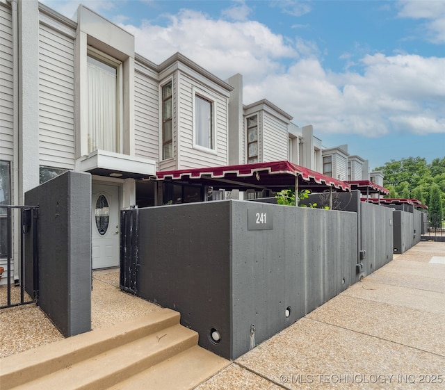 410 W 7th St Unit 241, Tulsa, OK 74119 - view of home's exterior with a fenced front yard