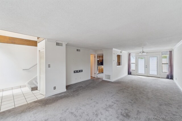 410 W 7th St Unit 241, Tulsa, OK 74119 - unfurnished living room with crown molding, carpet, a textured ceiling, a chandelier, and stairs