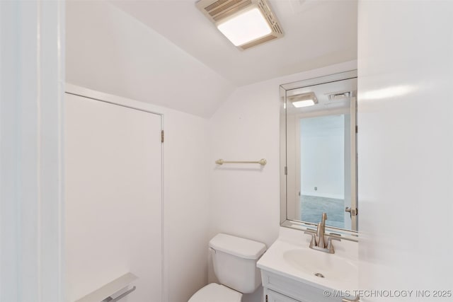 410 W 7th St Unit 241, Tulsa, OK 74119 - bathroom with toilet, vanity, and vaulted ceiling