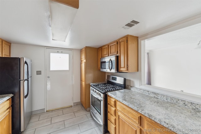 410 W 7th St Unit 241, Tulsa, OK 74119 - kitchen with stainless steel appliances and light tile patterned floors