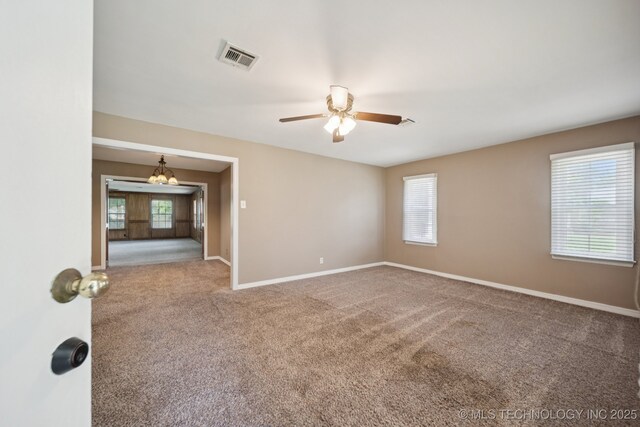 3218 S Kingston Ave, Tulsa, OK 74135 - carpeted empty room featuring a ceiling fan and a chandelier