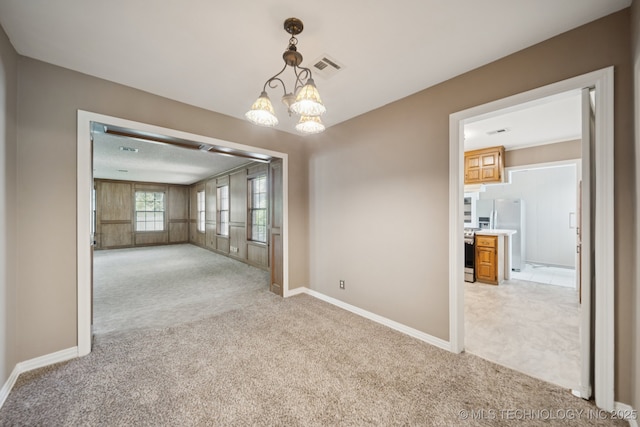 3218 S Kingston Ave, Tulsa, OK 74135 - spare room with light colored carpet and a chandelier