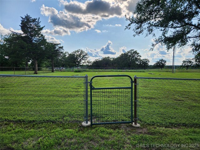 307 N W St, Mcalester, OK 74501 - view of yard with a gate and a rural view