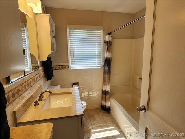 307 N W St, Mcalester, OK 74501 - bathroom with toilet, vanity, tile patterned floors, shower / tub combo, and tile walls