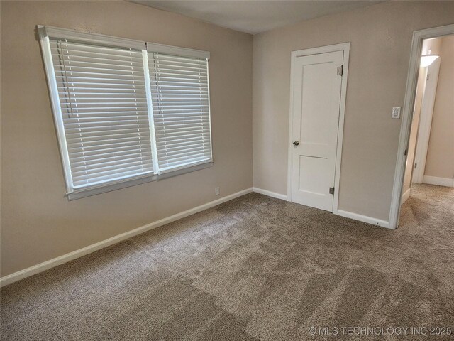 307 N W St, Mcalester, OK 74501 - carpeted empty room with baseboards