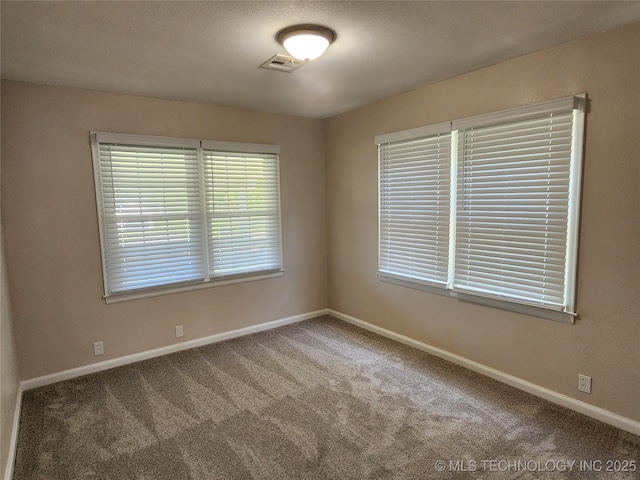 307 N W St, Mcalester, OK 74501 - spare room featuring baseboards and carpet flooring