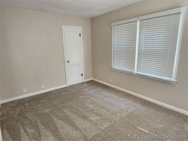 307 N W St, Mcalester, OK 74501 - spare room featuring baseboards and carpet