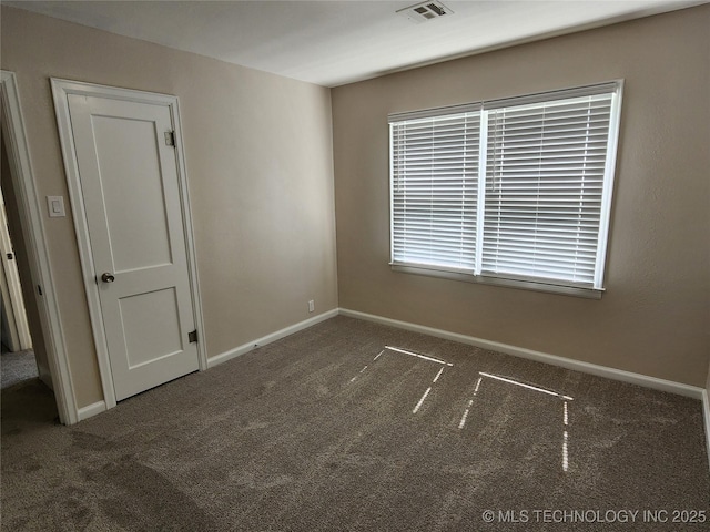 307 N W St, Mcalester, OK 74501 - spare room featuring carpet floors and baseboards