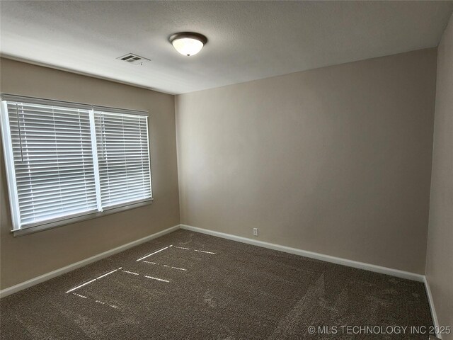 307 N W St, Mcalester, OK 74501 - carpeted empty room featuring baseboards