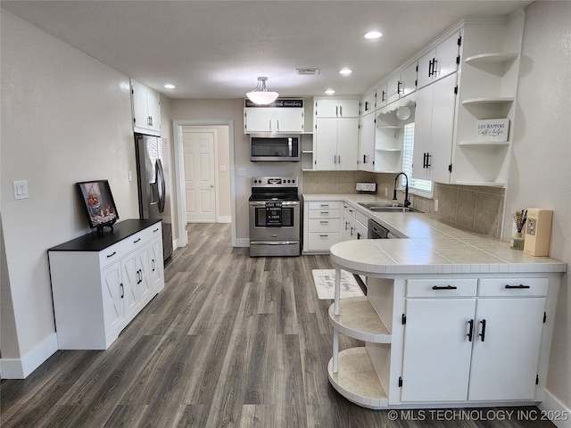 307 N W St, Mcalester, OK 74501 - kitchen with open shelves, appliances with stainless steel finishes, a sink, white cabinets, and recessed lighting