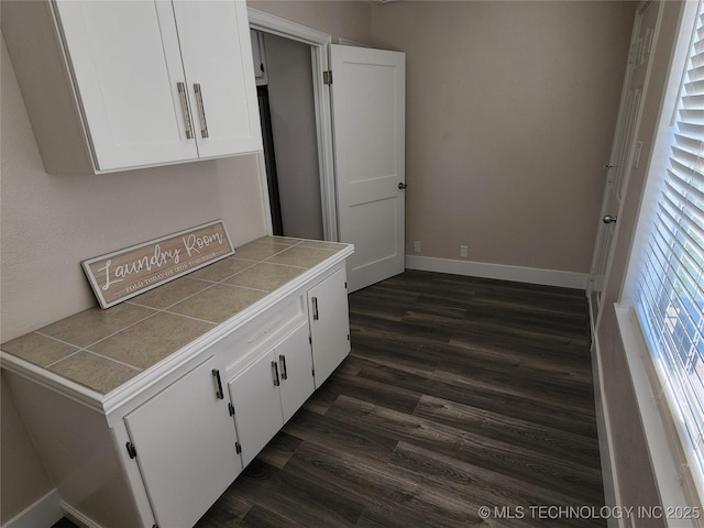 307 N W St, Mcalester, OK 74501 - laundry room with dark wood-style floors and baseboards