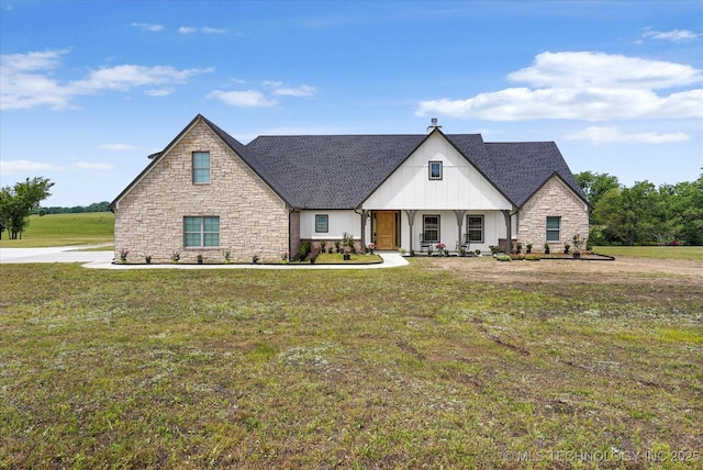 30185 N 3994th Dr, Ramona, OK 74061 - view of front of home featuring board and batten siding, stone siding, a front yard, covered porch, and a shingled roof
