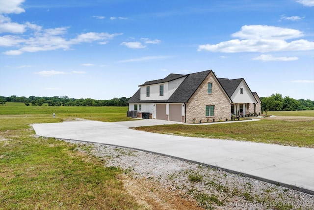 30185 N 3994th Dr, Ramona, OK 74061 - view of side of home with an attached garage, stone siding, driveway, and a lawn