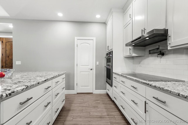 30185 N 3994th Dr, Ramona, OK 74061 - kitchen with black electric cooktop, under cabinet range hood, white cabinetry, decorative backsplash, and recessed lighting
