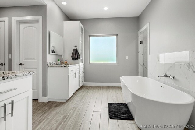30185 N 3994th Dr, Ramona, OK 74061 - full bath featuring vanity, a freestanding tub, wood finished floors, and recessed lighting