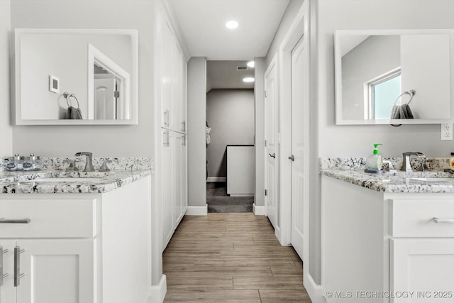 30185 N 3994th Dr, Ramona, OK 74061 - bathroom with two vanities, wood finished floors, and recessed lighting