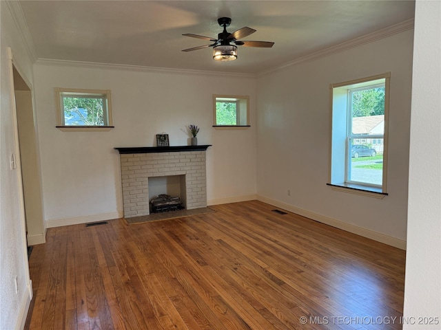 2109 Delaware St, Muskogee, OK 74403 - unfurnished living room featuring plenty of natural light, a fireplace, hardwood / wood-style floors, and crown molding