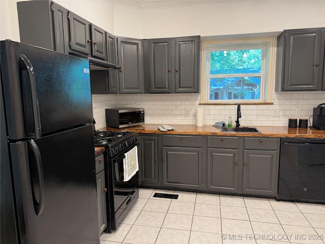 2109 Delaware St, Muskogee, OK 74403 - kitchen featuring black appliances, a sink, light tile patterned floors, gray cabinetry, and decorative backsplash