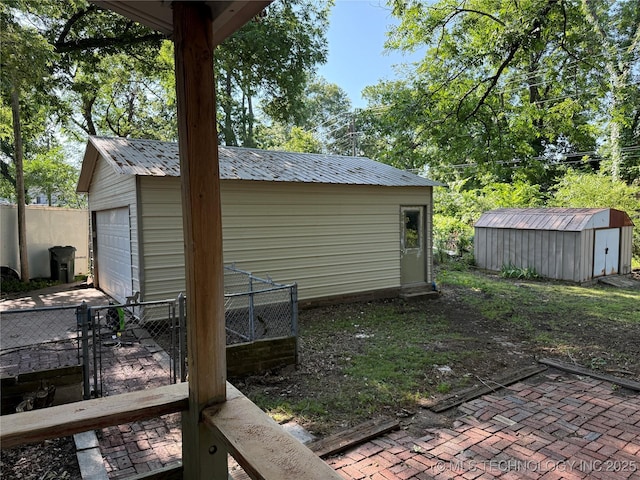 2109 Delaware St, Muskogee, OK 74403 - view of yard with an outbuilding, a detached garage, and a gate