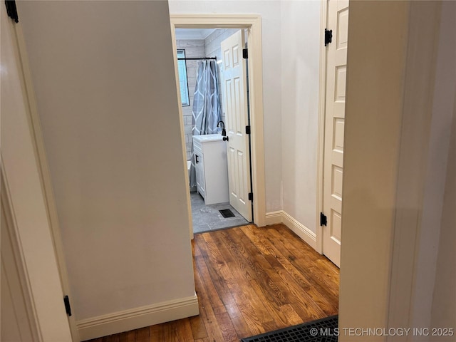 2109 Delaware St, Muskogee, OK 74403 - corridor featuring dark wood-type flooring and baseboards