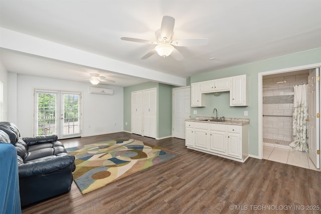 3508 Kimberlea, Muskogee, OK 74403 - living area with a ceiling fan, dark wood-style floors, a wall mounted AC, and baseboards