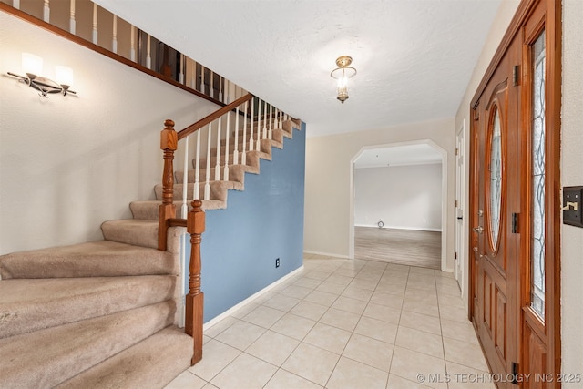 3508 Kimberlea, Muskogee, OK 74403 - foyer entrance featuring stairs, light tile patterned floors, baseboards, and arched walkways