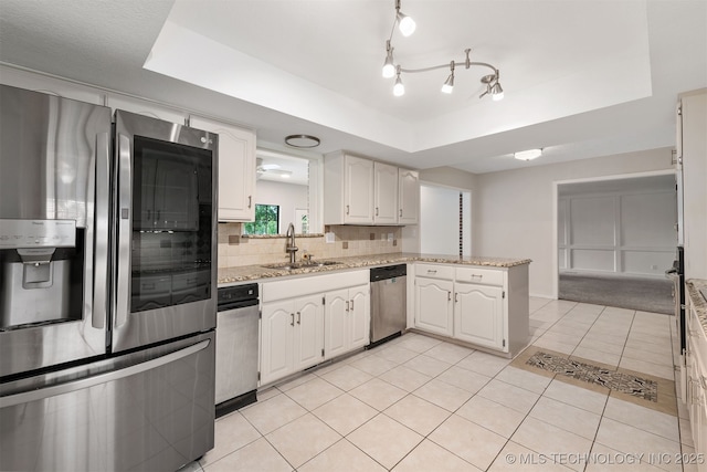 3508 Kimberlea, Muskogee, OK 74403 - kitchen featuring stainless steel appliances, a tray ceiling, a sink, tasteful backsplash, and white cabinets