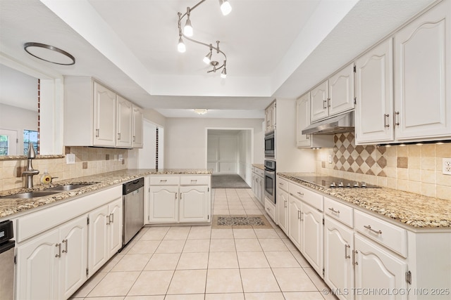 3508 Kimberlea, Muskogee, OK 74403 - kitchen featuring appliances with stainless steel finishes, a sink, under cabinet range hood, a peninsula, and a raised ceiling