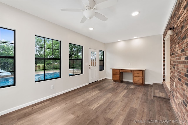 3508 Kimberlea, Muskogee, OK 74403 - unfurnished office featuring dark wood-type flooring, baseboards, recessed lighting, brick wall, and ceiling fan