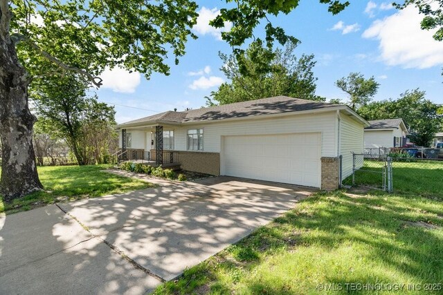 6210 E 17th St, Tulsa, OK 74112 - ranch-style house featuring brick siding, a garage, concrete driveway, and a porch