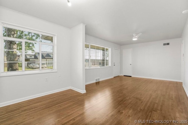 6210 E 17th St, Tulsa, OK 74112 - spare room featuring wood finished floors, baseboards, ceiling fan, and crown molding