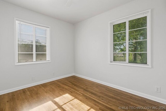 6210 E 17th St, Tulsa, OK 74112 - unfurnished room with ornamental molding, plenty of natural light, wood finished floors, and baseboards