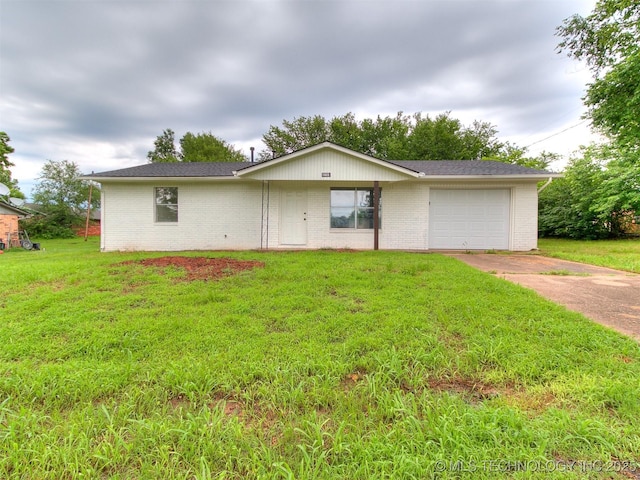 1405 S Cedar St, Bristow, OK 74010 - view of front of home featuring driveway, brick siding, an attached garage, and a front yard