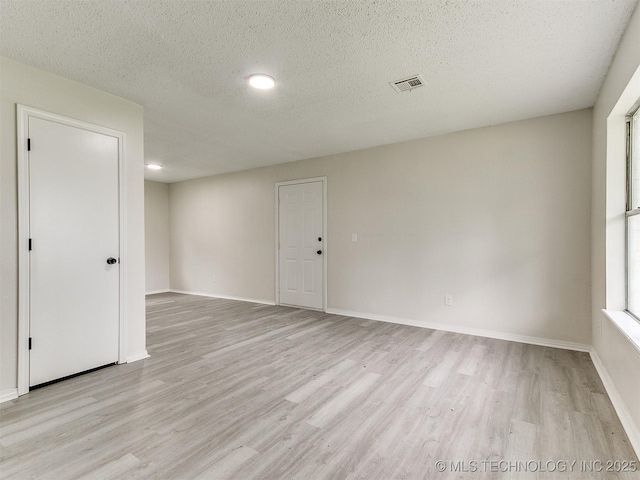 1405 S Cedar St, Bristow, OK 74010 - unfurnished room featuring light wood-style flooring and a textured ceiling