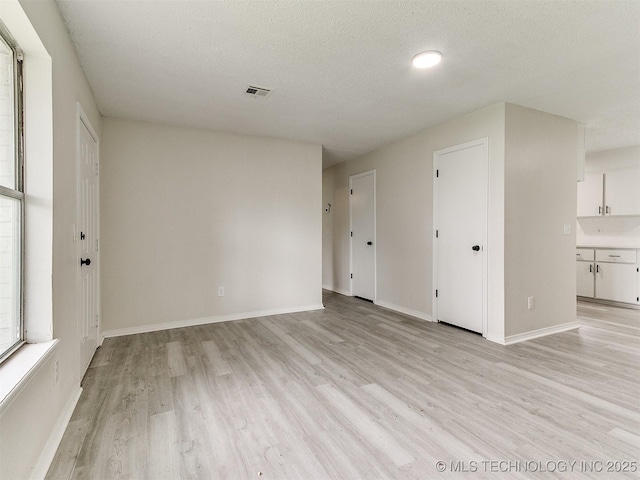 1405 S Cedar St, Bristow, OK 74010 - spare room featuring light wood-type flooring and a textured ceiling