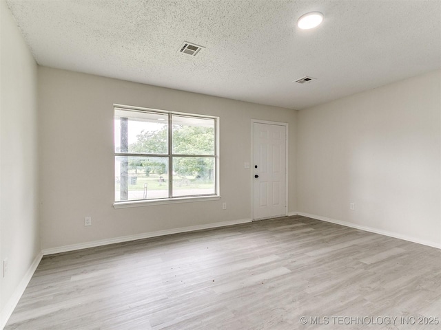 1405 S Cedar St, Bristow, OK 74010 - spare room featuring wood finished floors and a textured ceiling