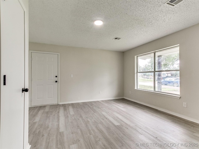 1405 S Cedar St, Bristow, OK 74010 - empty room with a textured ceiling and wood finished floors