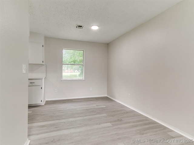 1405 S Cedar St, Bristow, OK 74010 - empty room with light wood-type flooring and a textured ceiling