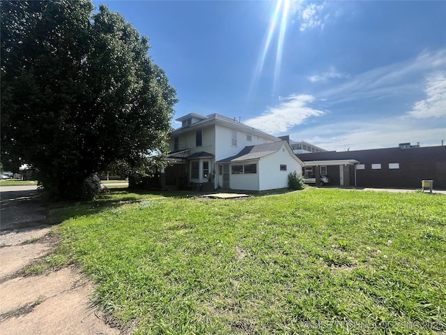 225 E 6th St, Pawhuska, OK 74056 - view of home's exterior with a yard